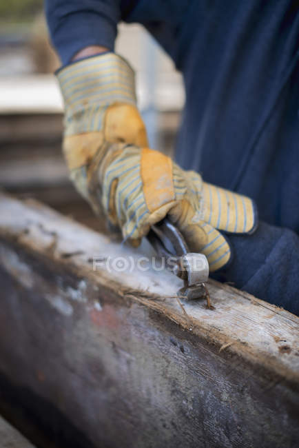 Man removing all the nails and studs. — Stock Photo