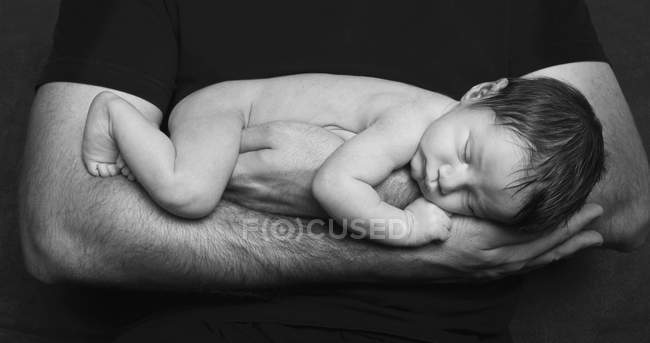Bebé recién nacido durmiendo en brazos
. - foto de stock