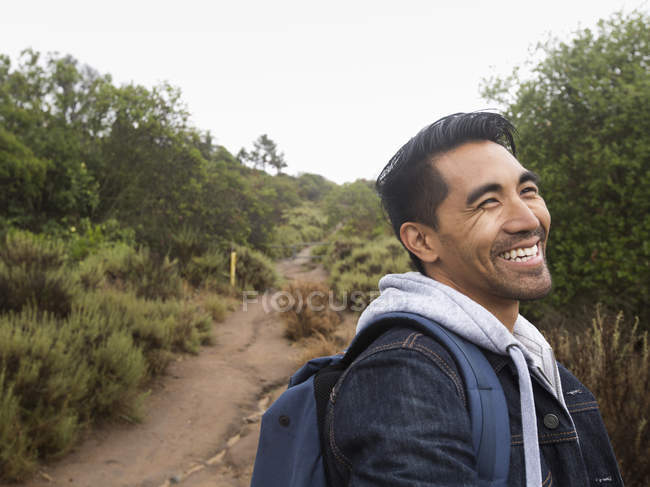 Smiling man in a park. — Stock Photo