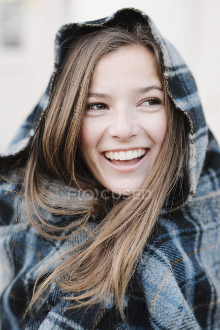 Teenage girl in a tartan plaid shawl — Stock Photo