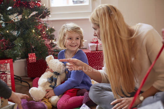 Mother and daughter unwrapping Christmas presents — Stock Photo