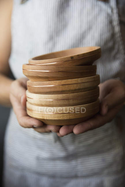 Woodworker holding turned wood bowls — Stock Photo