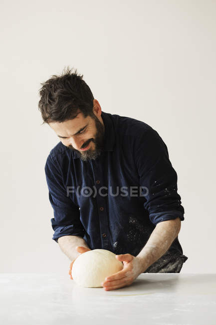 Baker kneading a portion of bread dough — Stock Photo