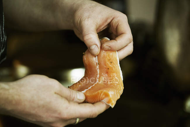 Chef holding fish fillet. — Stock Photo