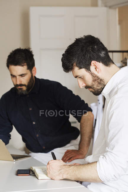 Two bearded men in a bakery — Stock Photo