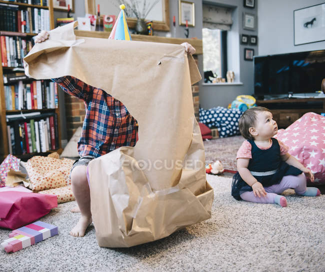 Boy unwrapping presents — Stock Photo