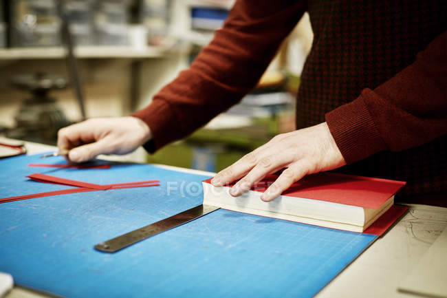 Man recovering book in workshop — Stock Photo