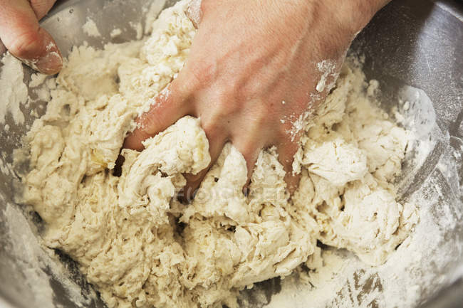 Baker kneading bread dough — Stock Photo