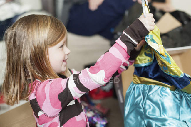 Mädchen packt Weihnachtsgeschenk aus. — Stockfoto