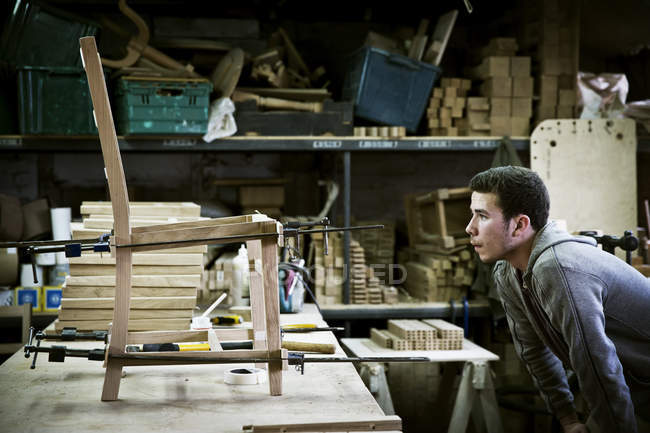 Man working in a furniture maker's workshop — Stock Photo