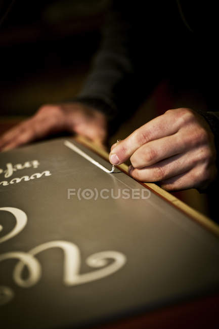 Signwriter working with loaded brush — Stock Photo
