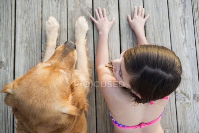 Young girl and a golden retriever dog — Stock Photo