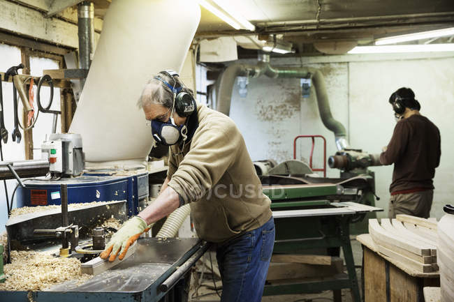 Man working on a piece of wood. — Stock Photo