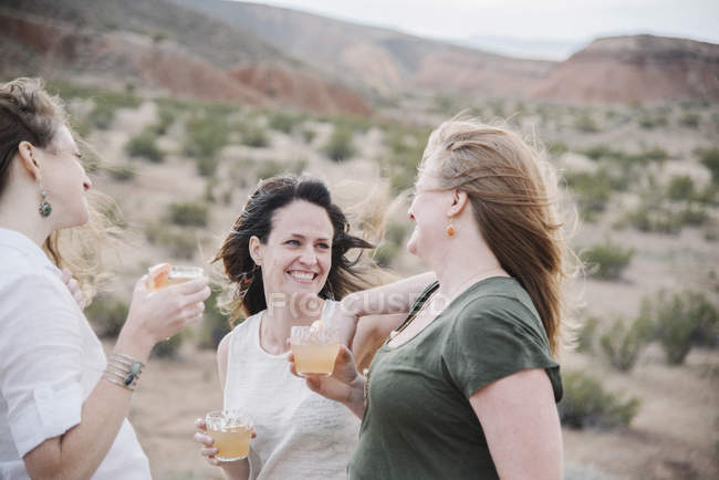Women standing in a desert landscape. — Stock Photo