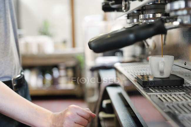 Fresh espresso running into a cup. — Stock Photo