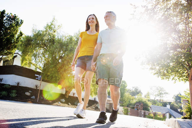 Senior couple walking along a street — Stock Photo