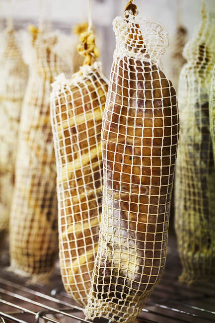 Air dried meat wrapped in nets — Stock Photo