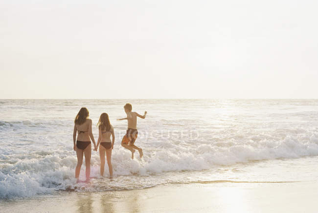 Children playing on sandy beach — Stock Photo