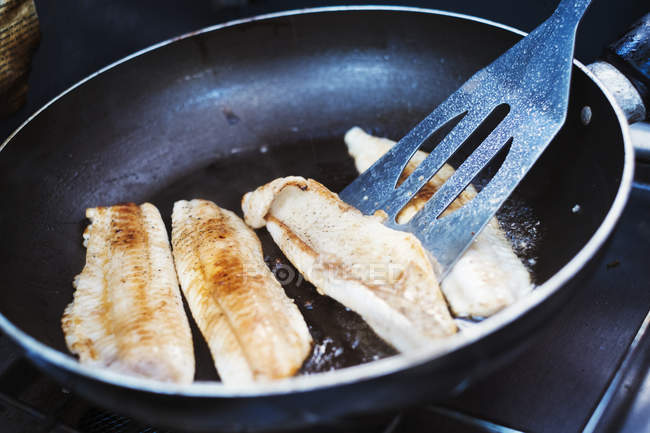 Fish fillets being fried — Stock Photo
