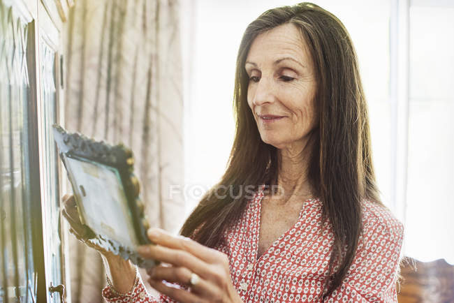 Donna anziana che guarda una foto . — Foto stock