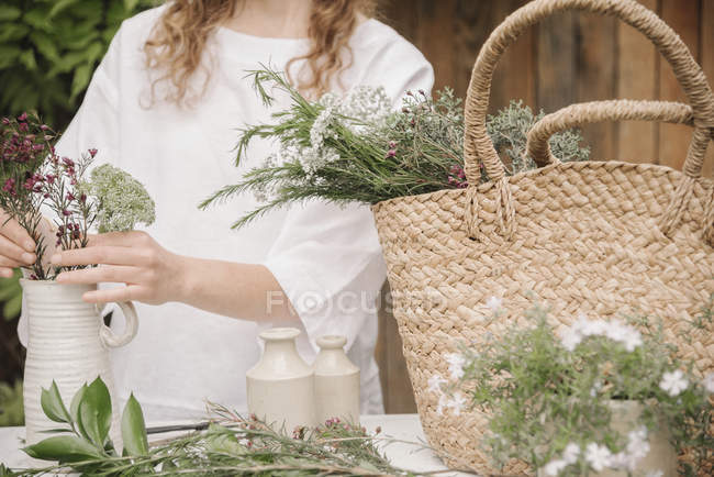 Woman preparing a mixture of herbs — Stock Photo