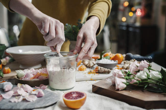 Woman mixing ingredients in a pot — Stock Photo