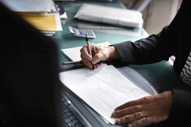 Businessman sitting at a desk in an office — Stock Photo