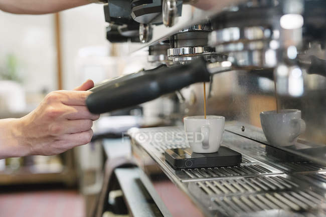 Man standing in front of espresso machine — Stock Photo