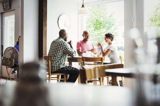 Men and woman having lunch in cafe — Stock Photo