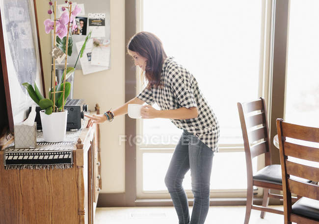 Woman switching on stereo. — Stock Photo