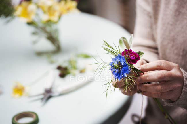 Florista criando casa de botão — Fotografia de Stock