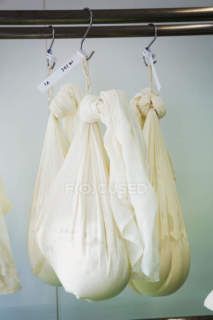 Gauze bags with goats cheese — Stock Photo
