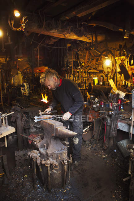 Blacksmith standing in his workshop. — Stock Photo