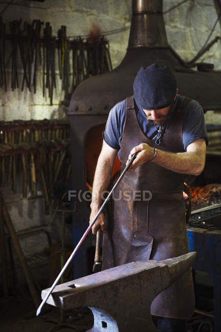 Blacksmith in a leather apron — Stock Photo