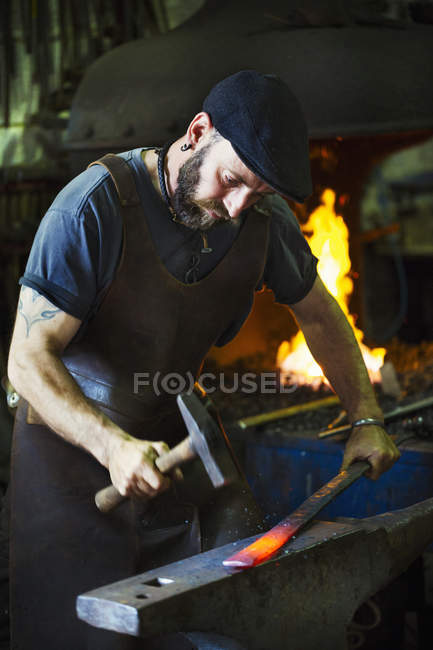Blacksmith in a leather apron — Stock Photo