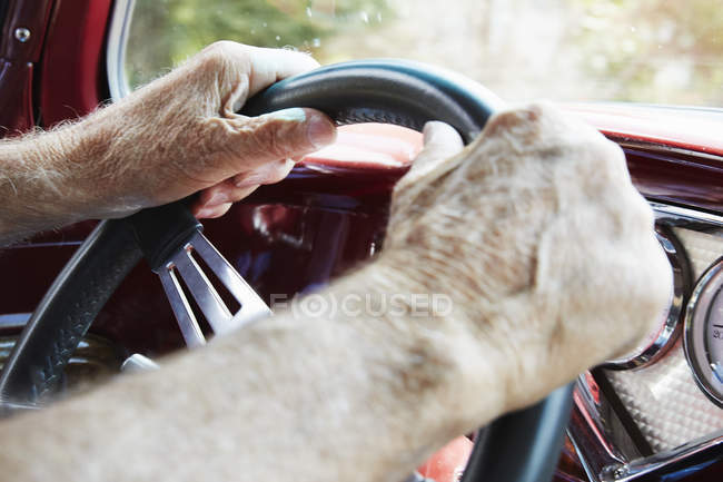 Hands holding steering wheel of a car — Stock Photo