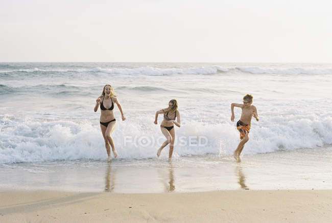 Enfants jouant sur la plage de sable — Photo de stock