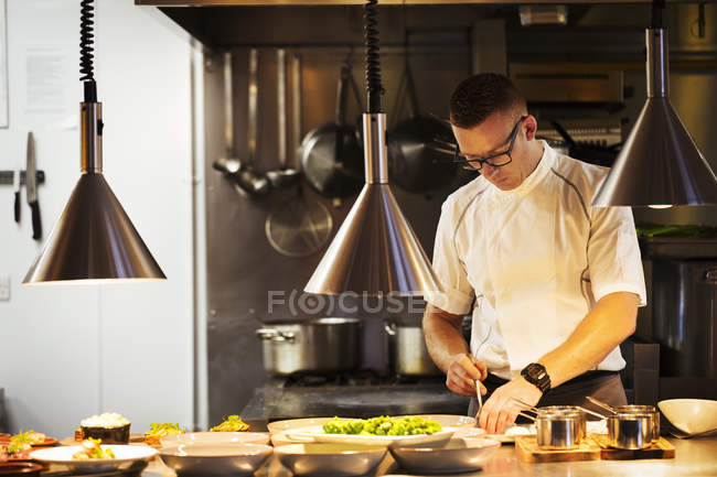 Chef cooking in restaurant — Stock Photo