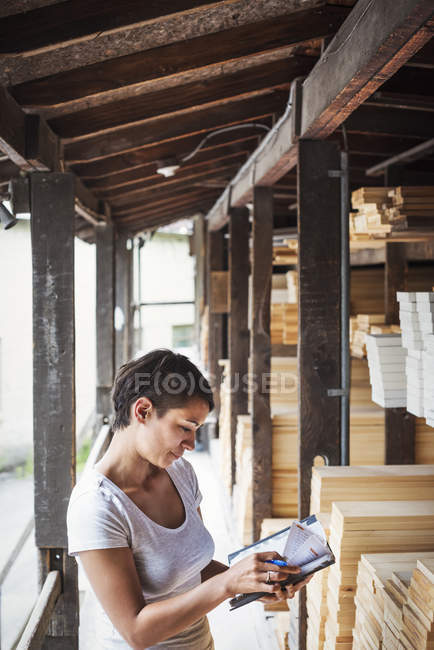 Mujer de pie en el patio de madera - foto de stock