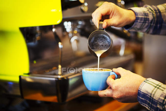 Barista making cup of espresso — Stock Photo