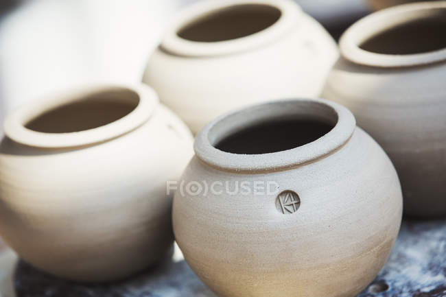 Four small round pots — Stock Photo