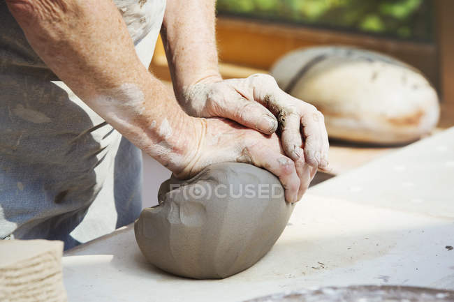Potter preparing a lump of damp clay — Stock Photo
