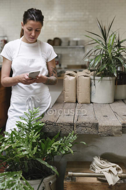 Woman standing in a kitchen — Stock Photo
