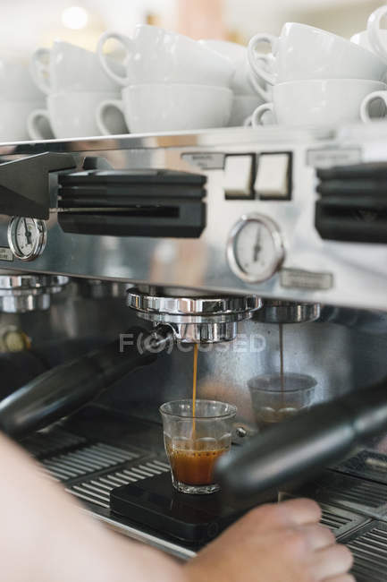 Man standing in front of espresso machine — Stock Photo