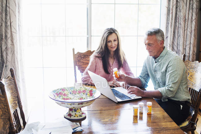 Senior couple  looking at a laptop computer. — Stock Photo