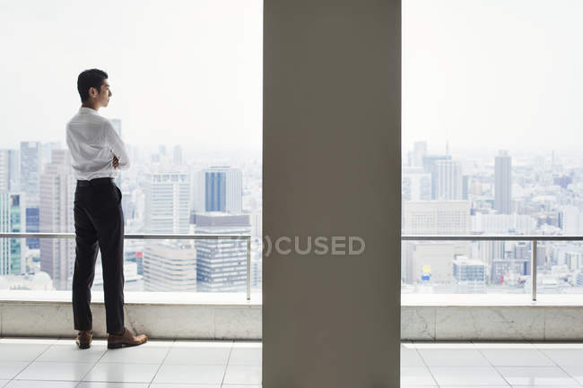 Businessman in the office standing by window — Stock Photo