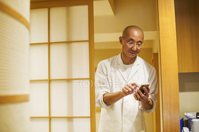 Chef in a small commercial kitchen — Stock Photo
