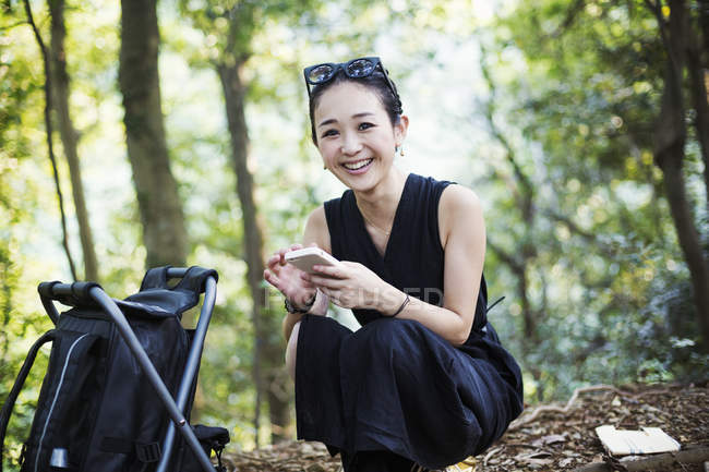 Woman sitting in a forest. — Stock Photo