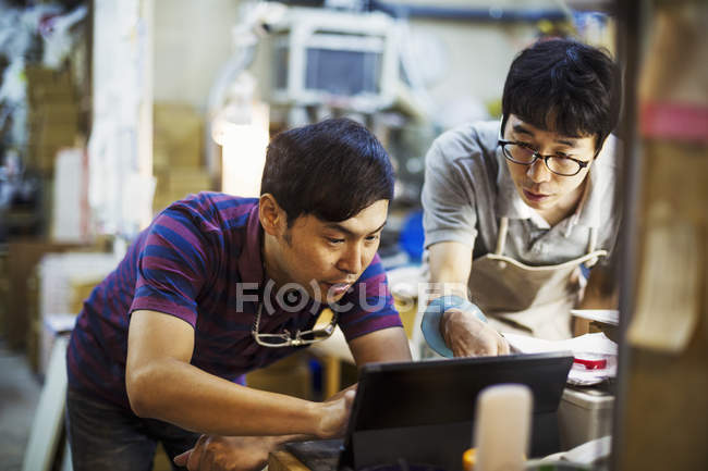 Men using a laptop computer — Stock Photo
