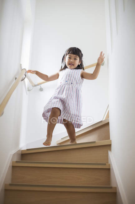 Girl walking down stairs. — Stock Photo